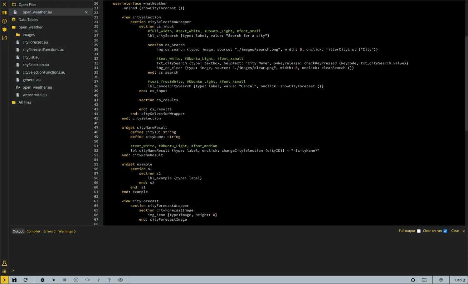 The Au code editor with a source file open on a dark background, keywords in gold, a project file tree on the left, and an integrated console.